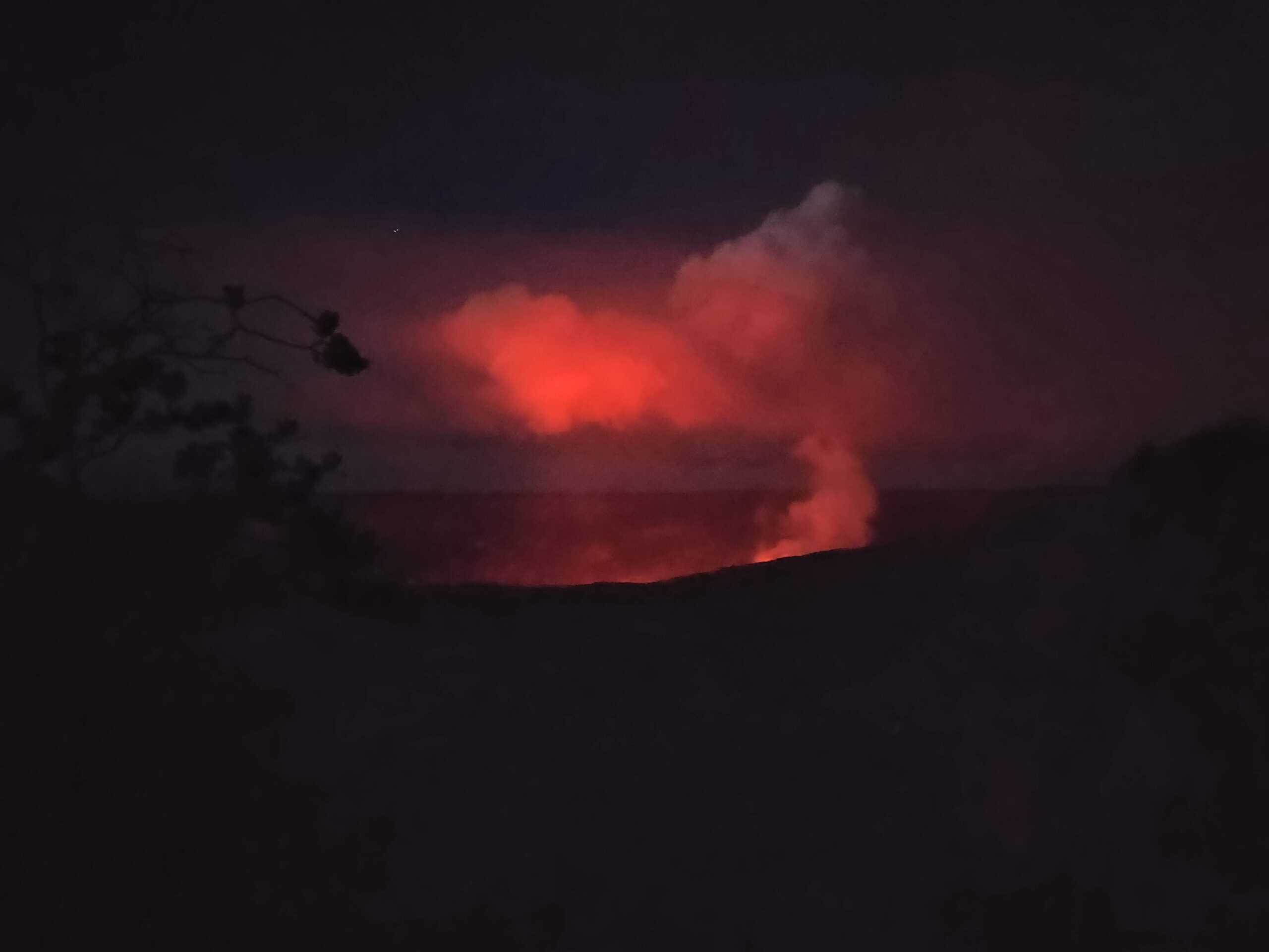 Lava glowing onto the clouds from the crater below. A perfect reason to visit Hawaii.